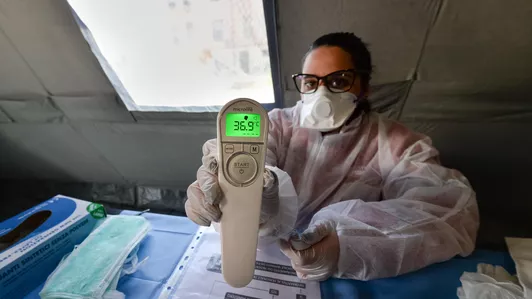 Red Cross volunteer with thermometer